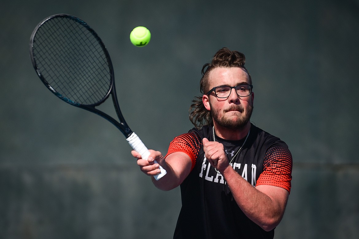 Flathead's Quaid Ring hits a return against Glacier's Harrison Sanders at Flathead Valley Community College on Thursday, April 14. (Casey Kreider/Daily Inter Lake)