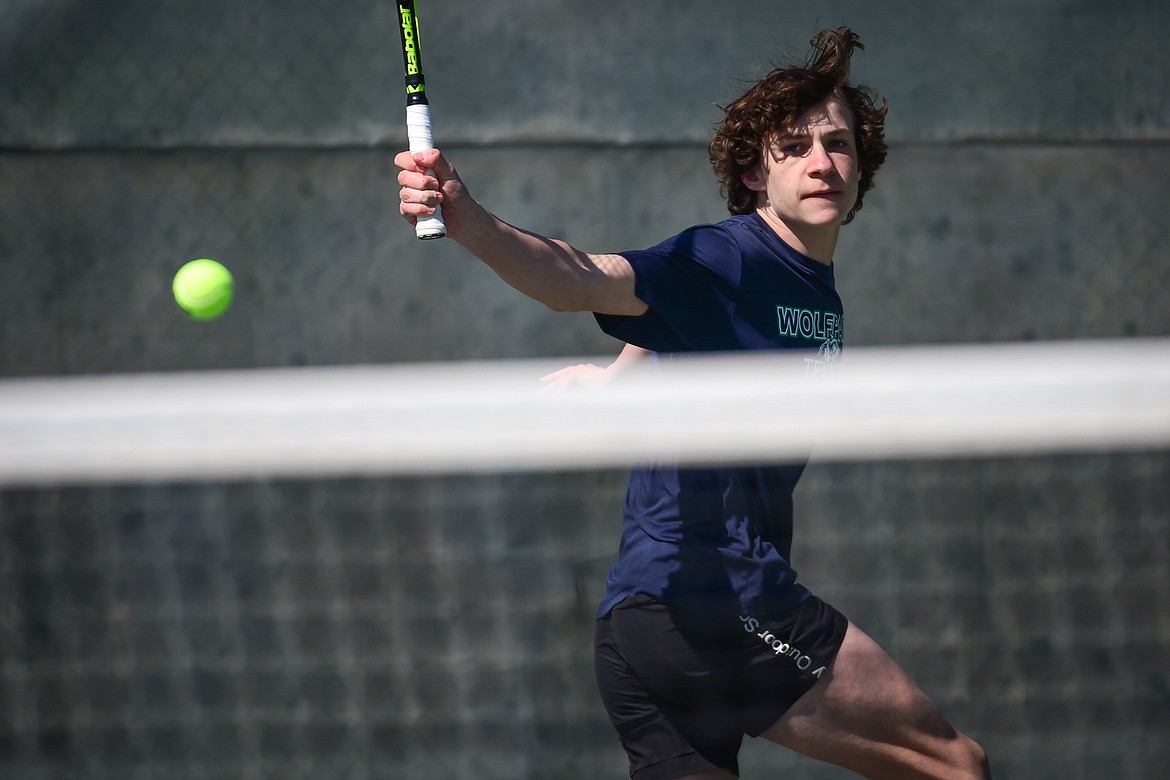 Glacier's Will Rudbach hits a backhand return against Flathead's Kutuk White at Flathead Valley Community College on Thursday, April 14. (Casey Kreider/Daily Inter Lake)