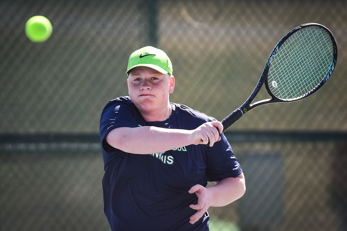 Glacier's Alex Galloway hits a return in a doubles match with teammate Timmy Glanville against Flathead's Evan Sevaly and Cody Ramer at Flathead Valley Community College on Thursday, April 14. (Casey Kreider/Daily Inter Lake)