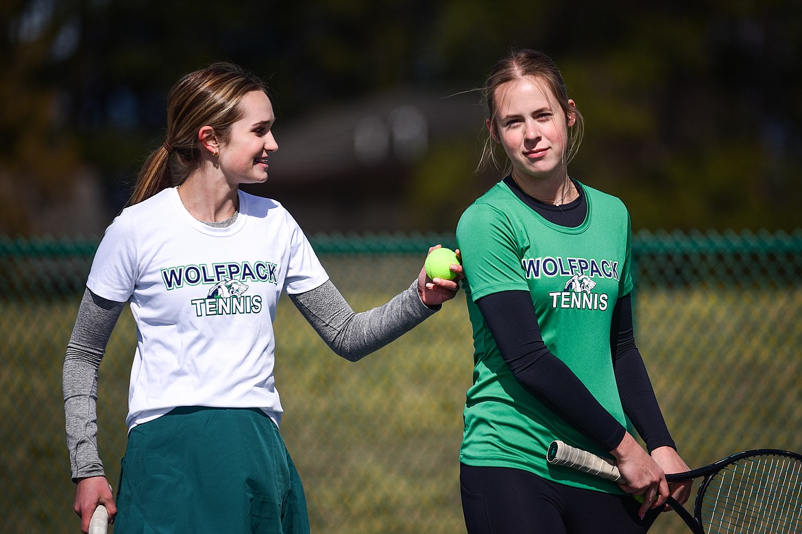 Glacier's girls doubles duo of Haven Speer and Sarah Downs chat between sets against Flathead's Sophie Dykhuizen and Abby Clark at Flathead Valley Community College on Thursday, April 14. (Casey Kreider/Daily Inter Lake)