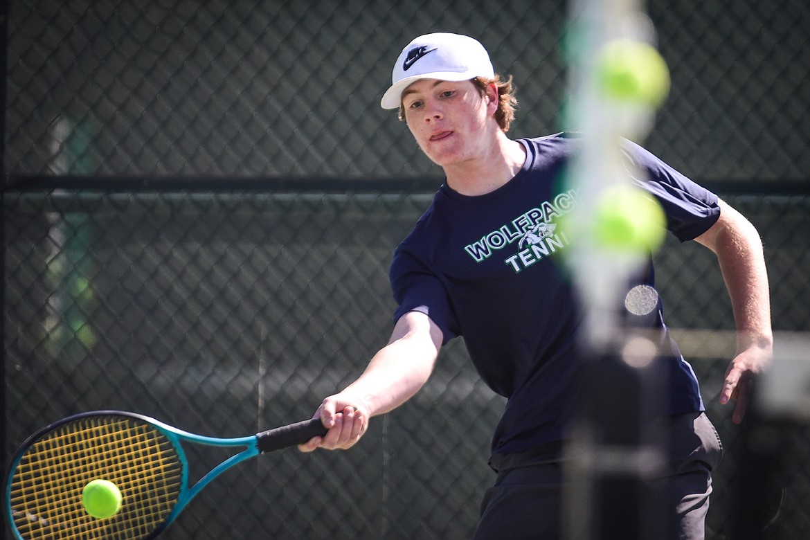 Glacier's Timmy Glanville hits a return in a doubles match with teammate Alex Galloway against Flathead's Evan Sevaly and Cody Ramer at Flathead Valley Community College on Thursday, April 14. (Casey Kreider/Daily Inter Lake)