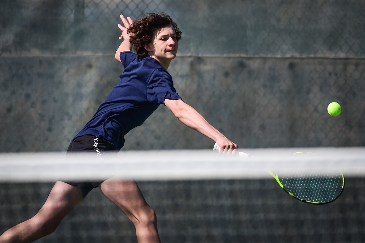 Glacier's Will Rudbach hits a backhand return against Flathead's Kutuk White at Flathead Valley Community College on Thursday, April 14. (Casey Kreider/Daily Inter Lake)