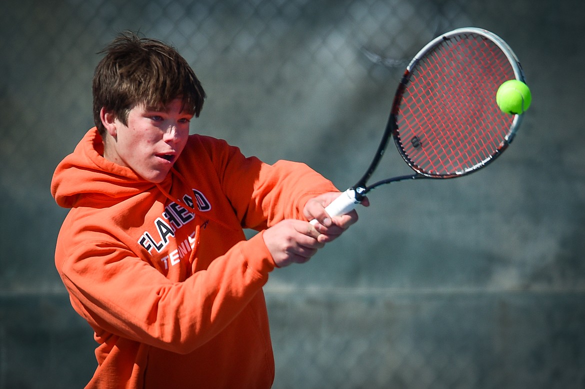 Flathead's Kutuk White hits a backhand return against Glacier's Will Rudbach at Flathead Valley Community College on Thursday, April 14. (Casey Kreider/Daily Inter Lake)