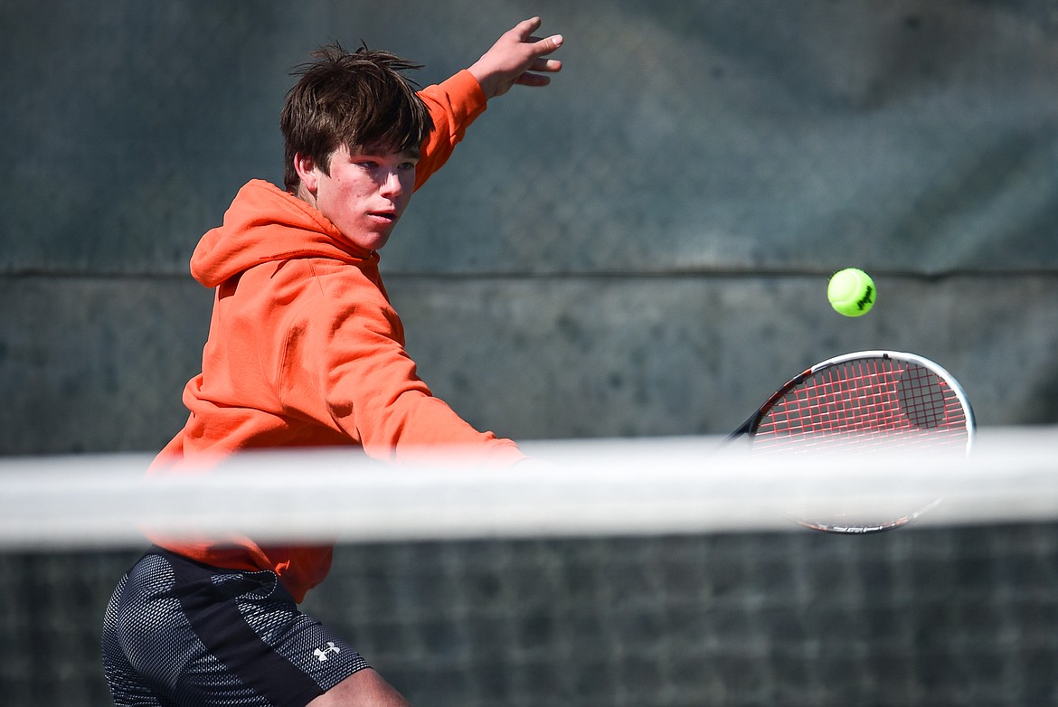 Flathead's Kutuk White hits a backhand return against Glacier's Will Rudbach at Flathead Valley Community College on Thursday, April 14. (Casey Kreider/Daily Inter Lake)