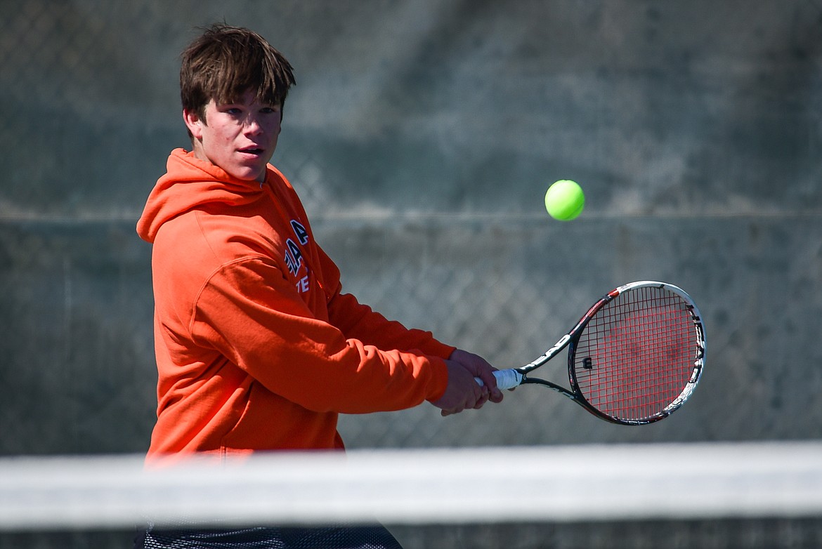 Flathead's Kutuk White hits a backhand return against Glacier's Will Rudbach at Flathead Valley Community College on Thursday, April 14. (Casey Kreider/Daily Inter Lake)