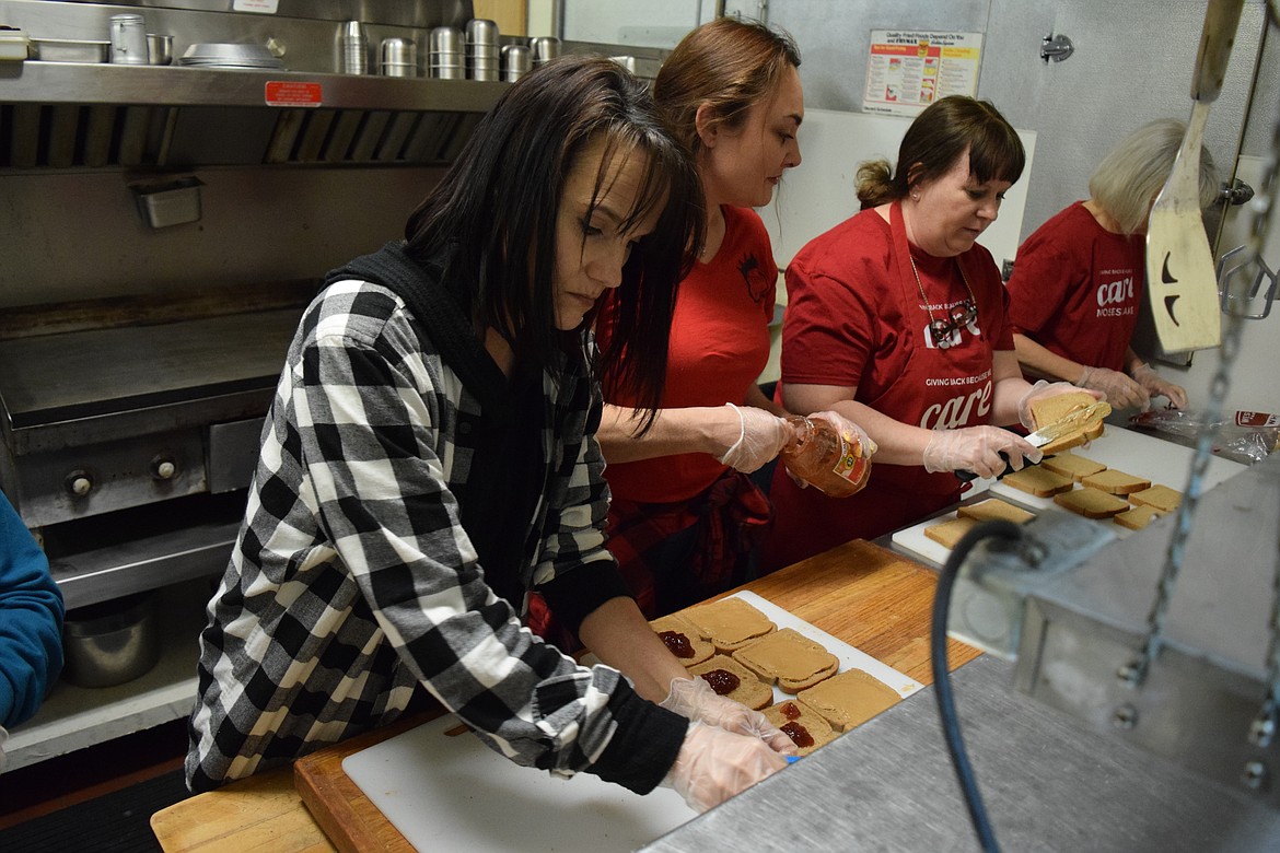 Care Moses Lake volunteers Pam Nordine, Amy Dana, Michaelle Boetger and Carol Bridges make sandwiches for the homeless on a recent Tuesday at the Elks Club in Moses Lake.