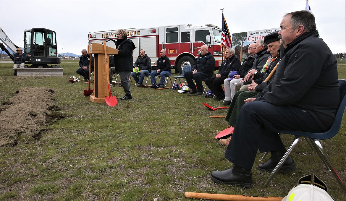 Kootenai County Fire & Rescue Board President Pam Houser addresses the crowd while Deputy Chief Dan Ryan, right, and others look on during Thursday's groundbreaking for the new fire station at the Kootenai County Fairgrounds.