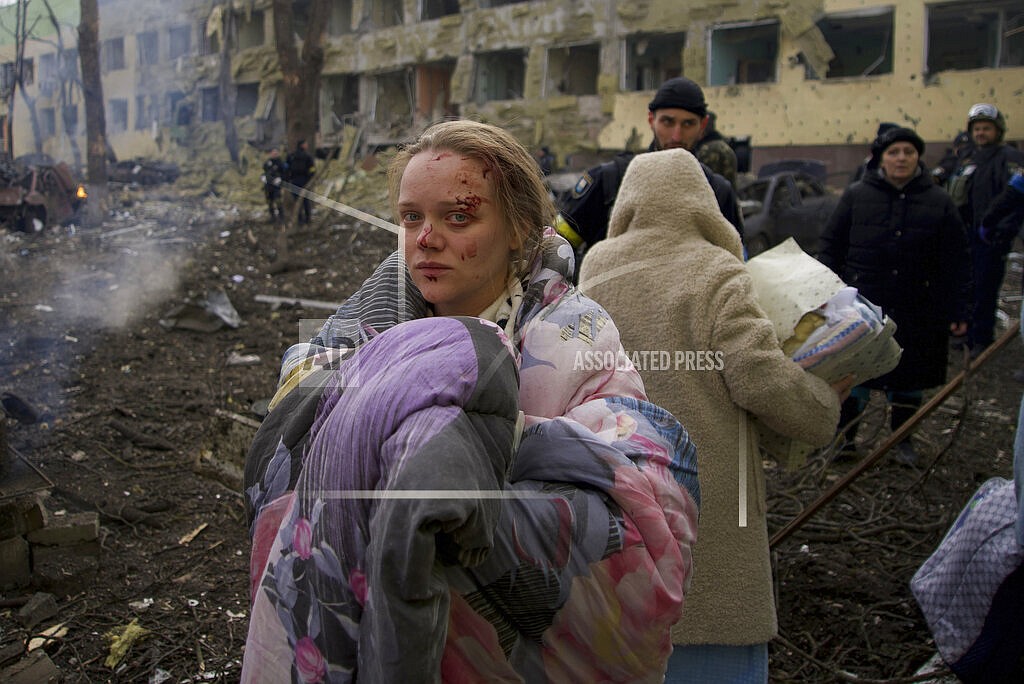 Marianna Vishegirskaya stands outside a maternity hospital that was damaged by shelling in Mariupol, Ukraine, Wednesday, March 9, 2022. (AP Photo/Mstyslav Chernov, File)