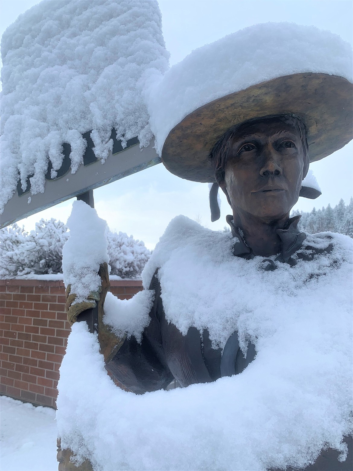 "The Suffragist," which was recently vandalized but quickly repaired, stands tall  on Front Avenue near McEuen Park, covered by snow on Friday.