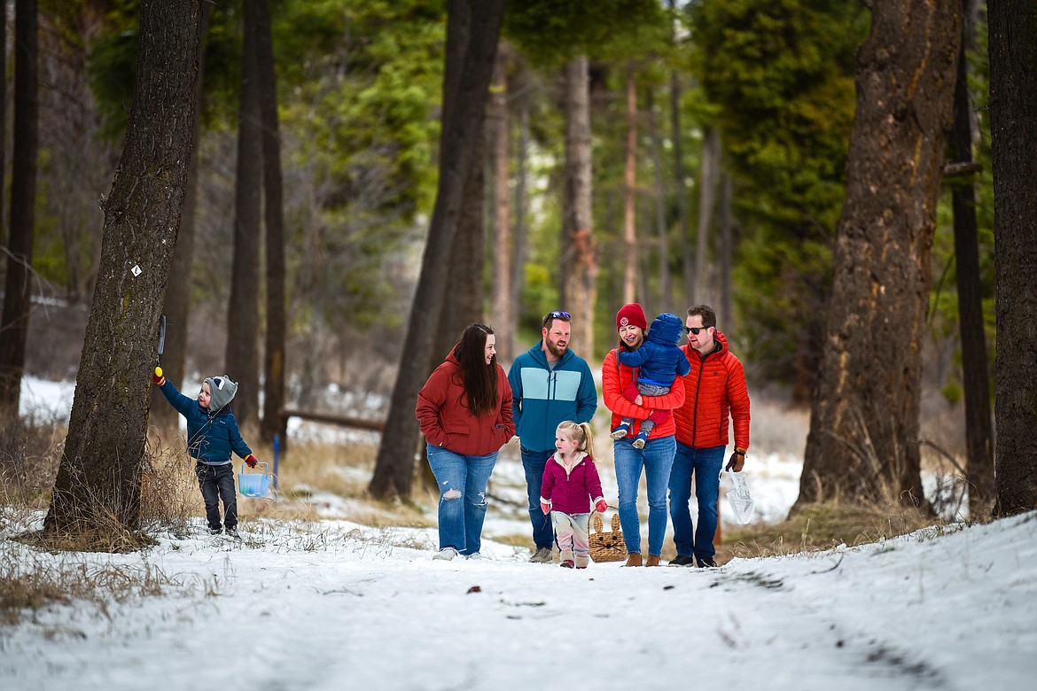 Families walk along a trail scooping up eggs during an Easter egg hunt at Lone Pine State Park in Kalispell on Saturday, April 16. (Casey Kreider/Daily Inter Lake)