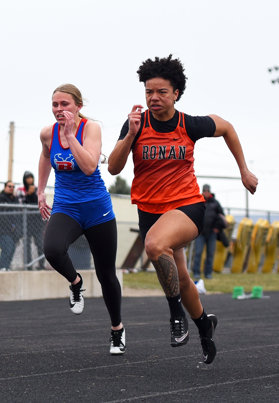 Ronan senior Adriana Tatukivei, right, won the 100 meters with a time of 13.41 seconds at the Dilly Bar Invitational. (Scot Heisel/Lake County Leader)