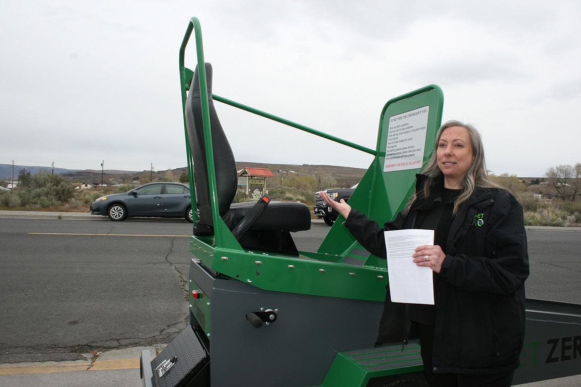 Allison Mitchell, Target Zero manager, shows off the new Seatbelt Convincer in its first outing Monday in Soap Lake.
