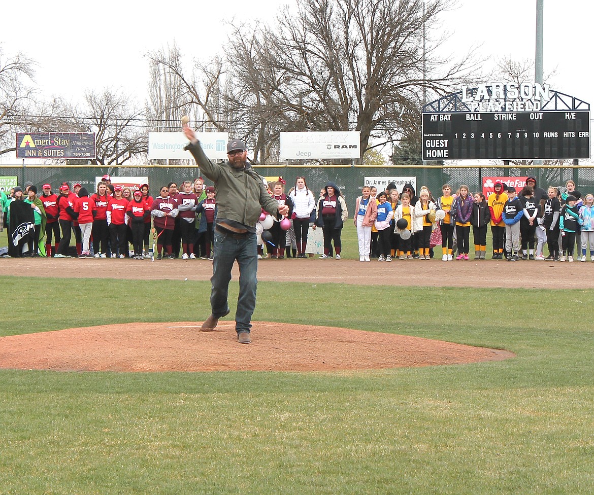 Ryan Doumit throws out the ceremonial first pitch at the Dick Kelly Memorial Youth Day Parade Saturday. Doumit is a former major league baseball player who now coaches baseball at Big Bend Community College.