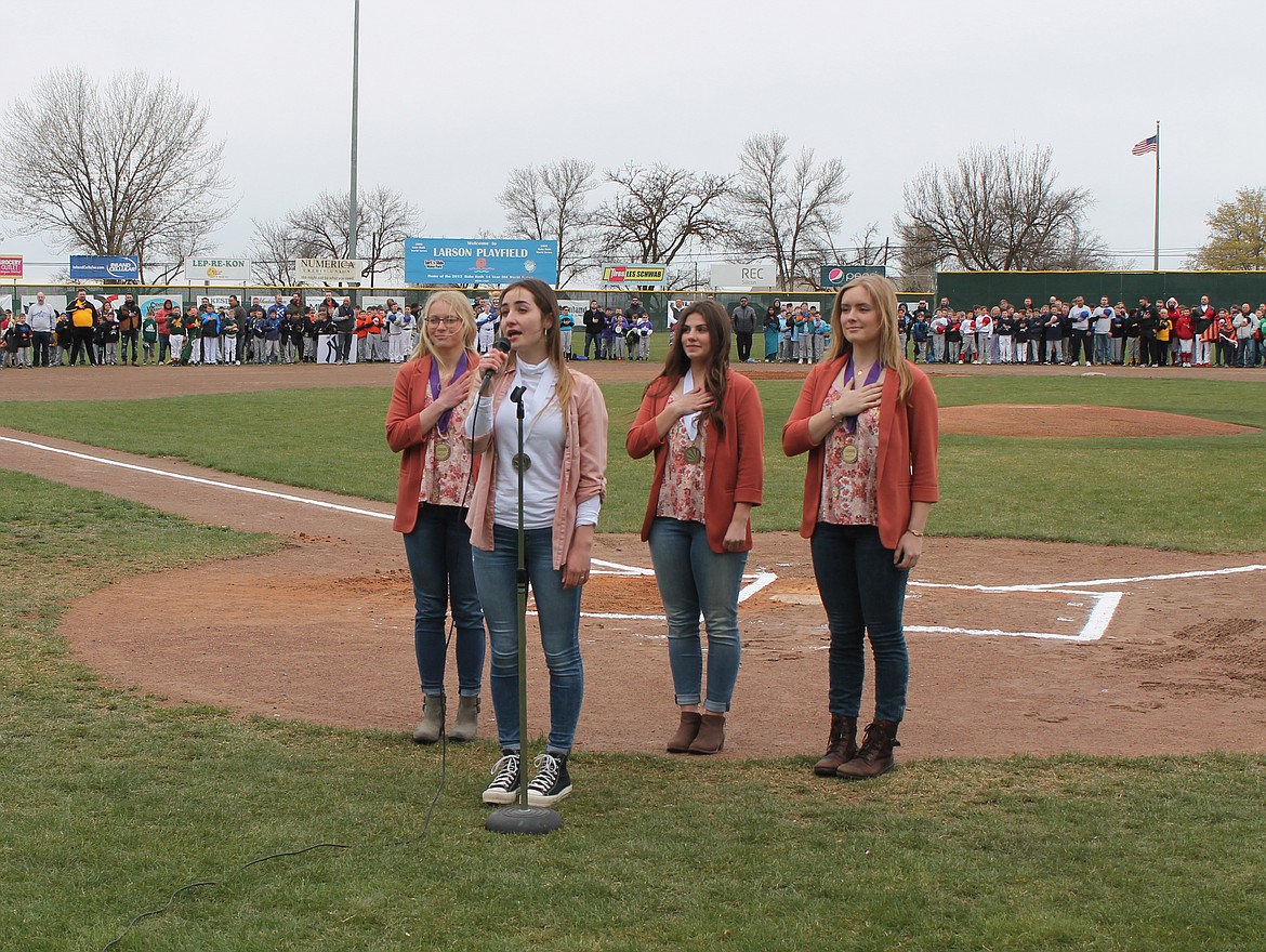 Esther Roeber, front, sings the National Anthem at the Dick Kelly Memorial Youth Day opening ceremony Saturday. Accompanying her are (from left) Lydia Jensen, Emma Fulkerson and McKenna Meise.