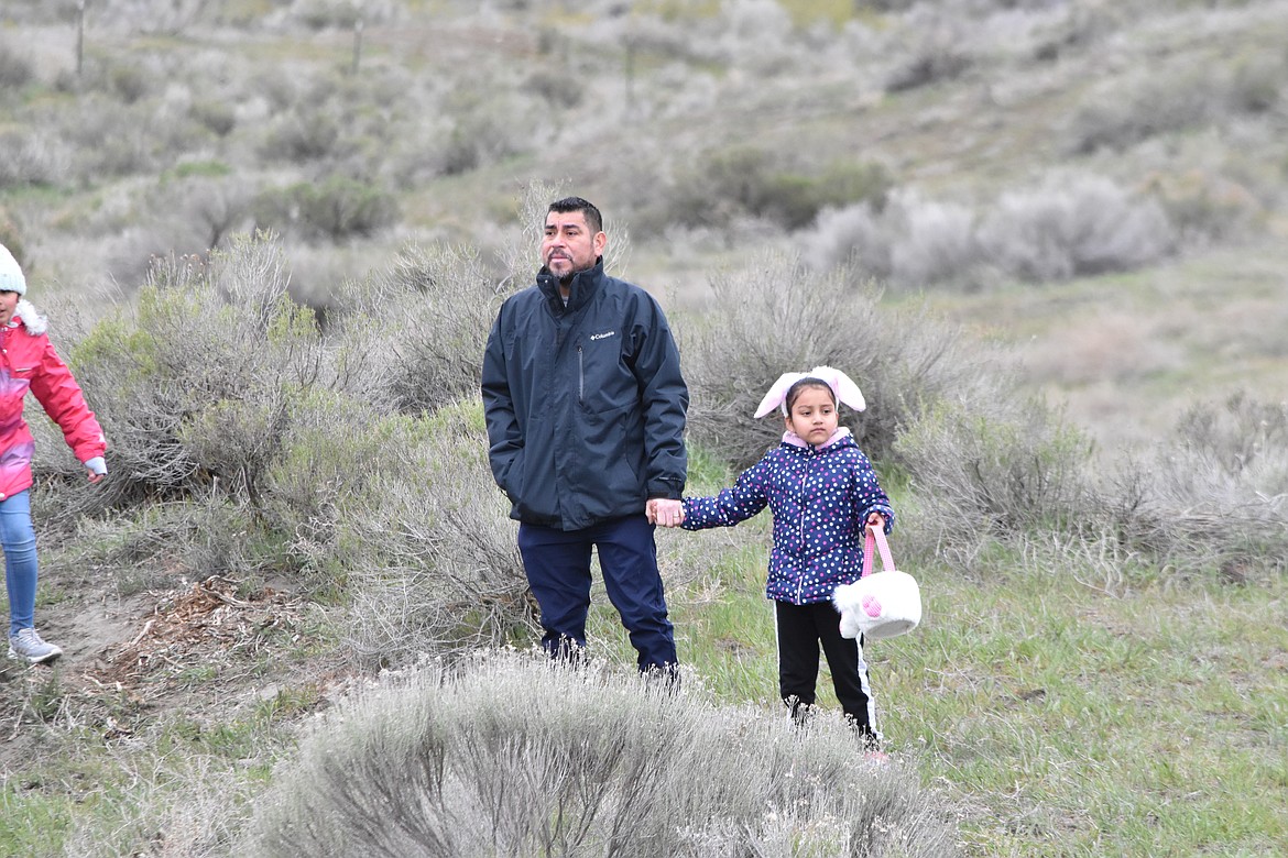 Some parents helped their children hunt for eggs.