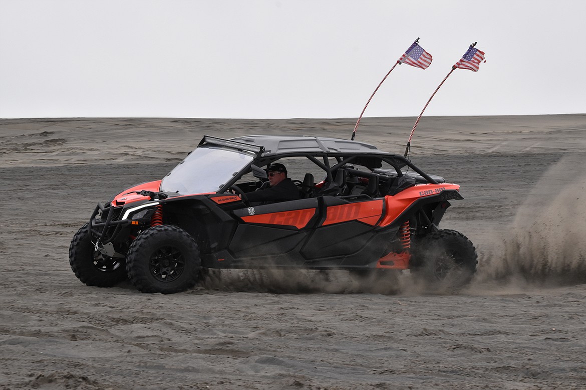 As participants waited for the poker run to start, they had fun taking off and throwing up sand.