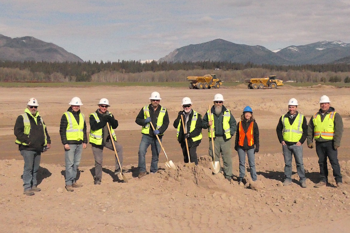 Officials from Plains and various construction/engineering firms gather last week for the traditional first shovel of dirt at the new site near the Plains airport. (Chuck Bandel/VP-MI)
