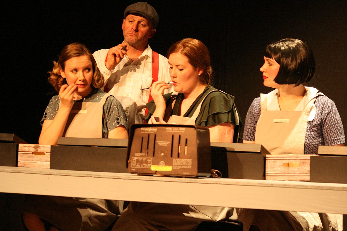 Under the watchful eye of their boss Mr. Reed (Jason Noble, background), (from left) Frances (Abby Burlingame), Charlotte (Allison Pheasant) and Catherine (Mistya Zaleski) go about their work - using a substance that will kill them in the Masquers Theater production of “These Shining Lives.” The play opens April 22.