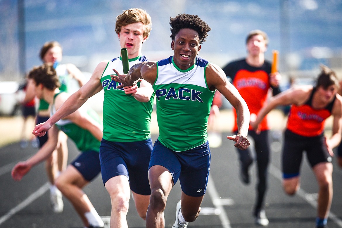 Glacier's Jeff Lillard takes the baton from Connor Sullivan during the boys 400 meter relay at a crosstown track and field meet at Glacier High School on Tuesday, April 19. (Casey Kreider/Daily Inter Lake)