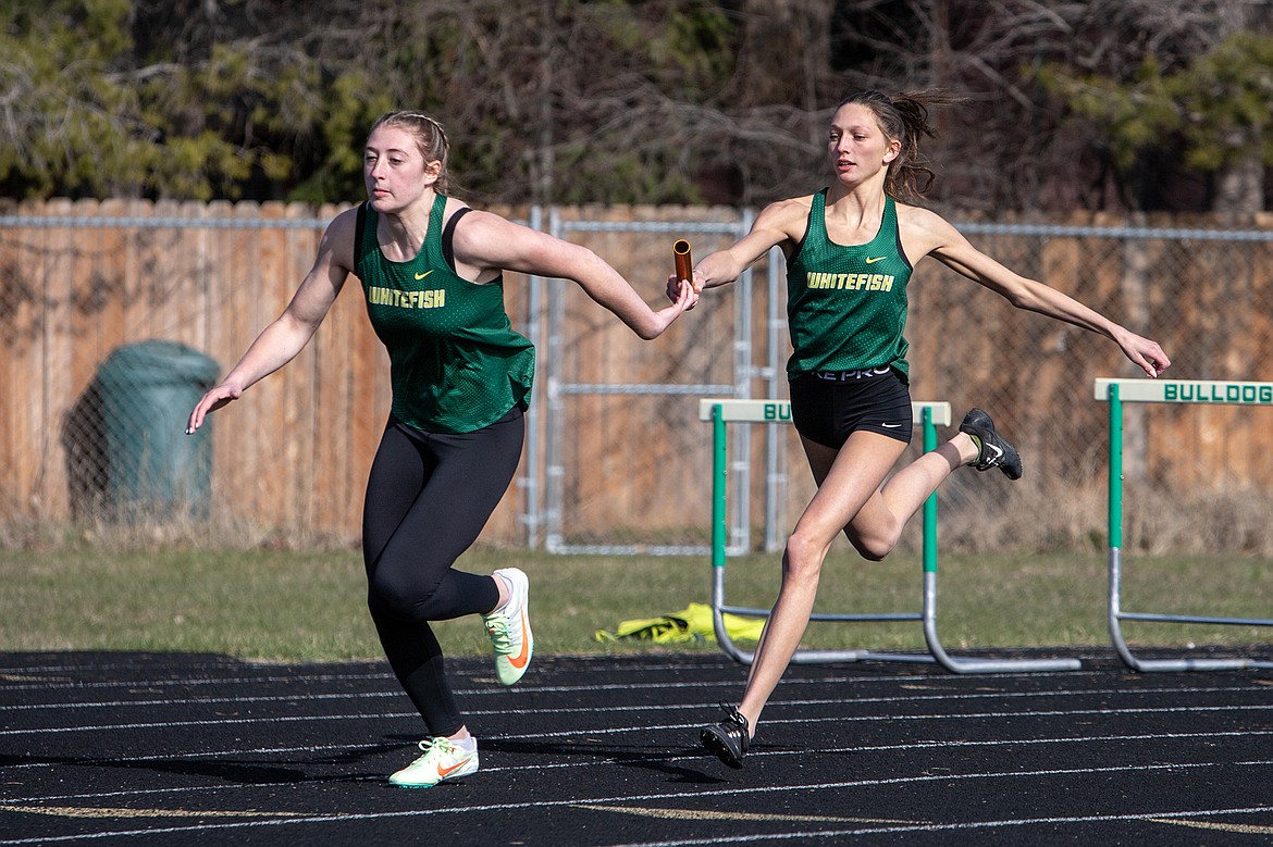 Bulldogs Brooke Zetooney and Erin Wilde compete in a relay race during the Dog-Cat meet at WHS on Thursday. (JP Edge photo)