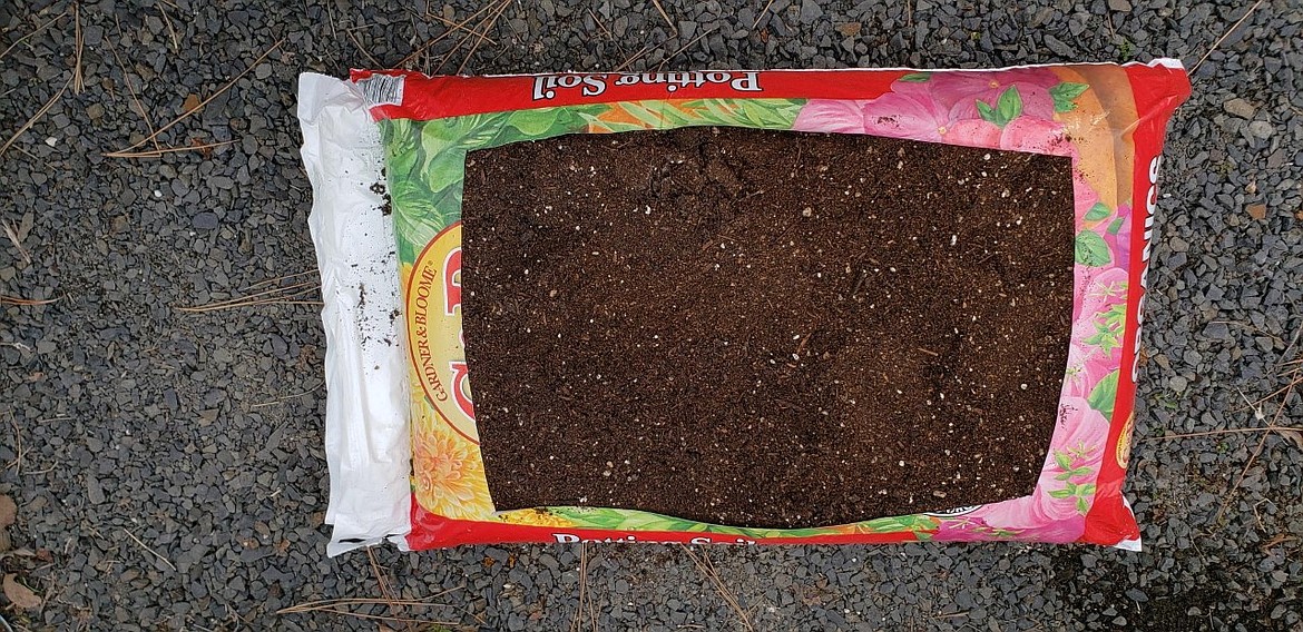 Cut a large rectangle in the top of the potting soil bag, leaving the sides in tact to hold in the soil. This makes a perfect, compact garden-in-a-bag.