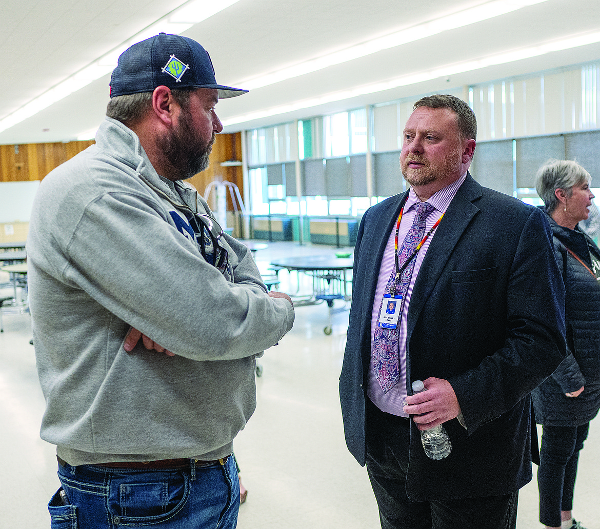 Jon Konen, right, talks with school board candidate and resident Justin Cheff last week during a meet-and-greet. Konen was selected as the new principal of Columbia Falls High School. (Chris Peterson/Hungry Horse News)