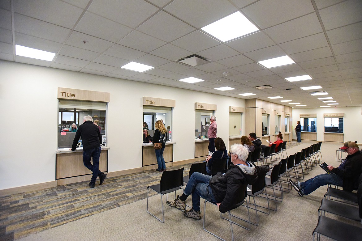 Customers stand at windows in the county treasurer's office inside the new North Complex building in Kalispell on Wednesday, April 20. (Casey Kreider/Daily Inter Lake)