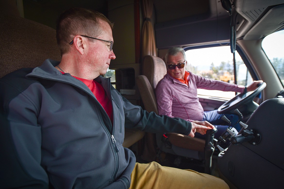 Flathead Valley Community College CDL instructor Mark Twichel, left, with former FVCC CDL student Bernard Jourdain in one of the college's 18-wheelers on Wednesday, April 20. (Casey Kreider/Daily Inter Lake)