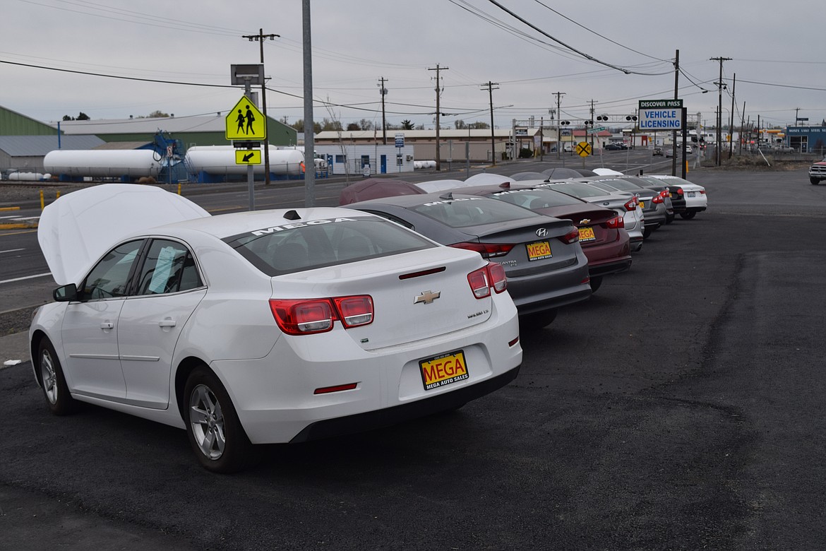 Cars on display at Mega Auto Sales. Owner Eric Gutierrez advises all potential buyers to know what they can afford — both in a down payment as well as in monthly payments — before coming in to buy a car.