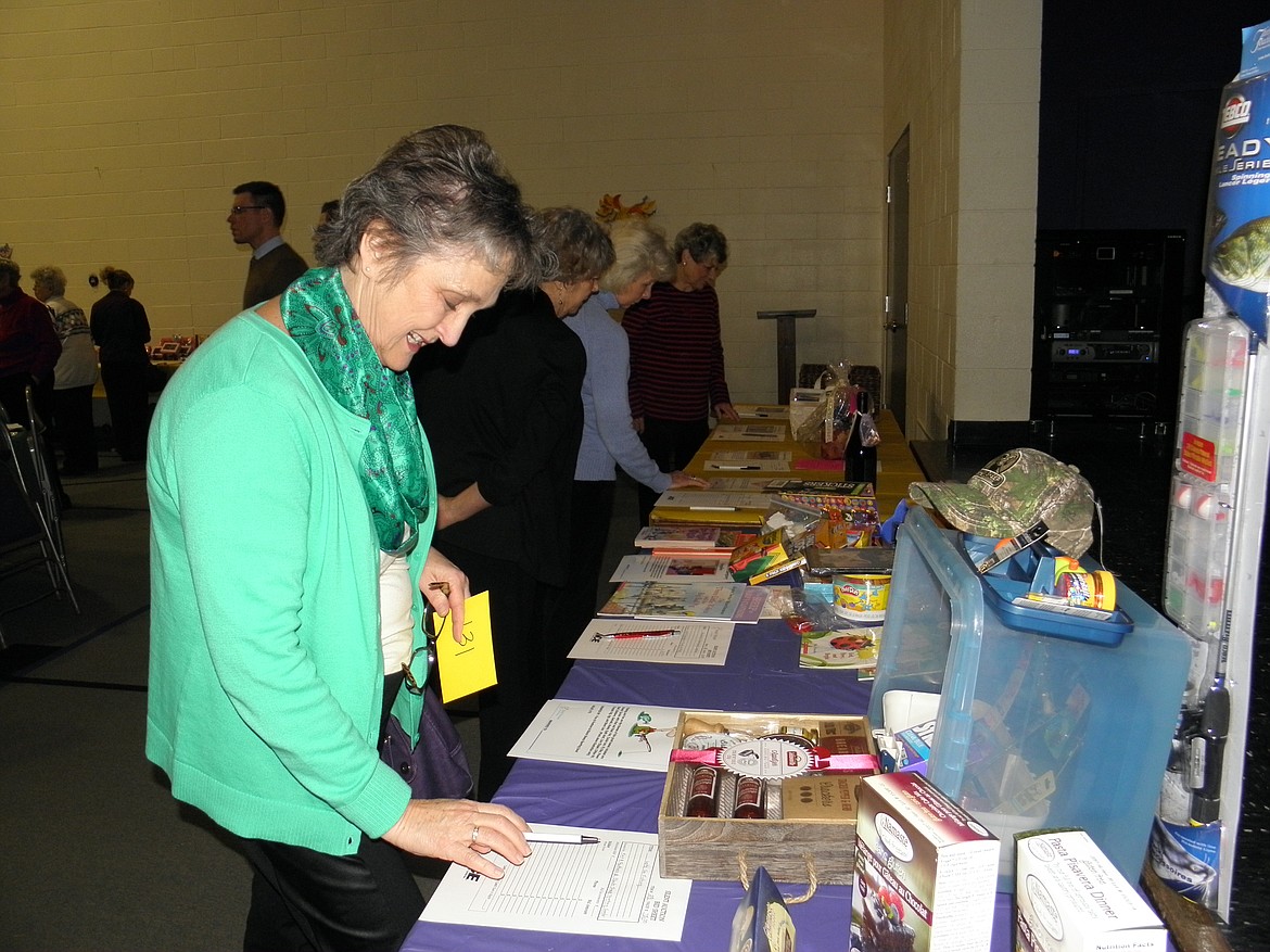 Susan Almeida inspects auction goodies at a past Family Promise Cinco de Mayo Fiesta. This year's event is May 5 in The Coeur d'Alene Resort.