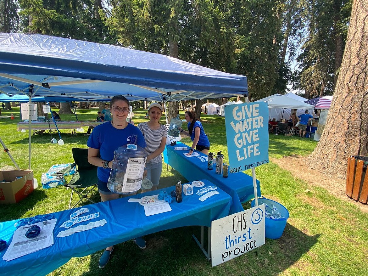 Coeur d'Alene High School senior Zoey Hart holds a gallon of change at last summer's fundraiser to fund a well in Africa through the Thirst Project. Photo courtesy of Emily Forslof