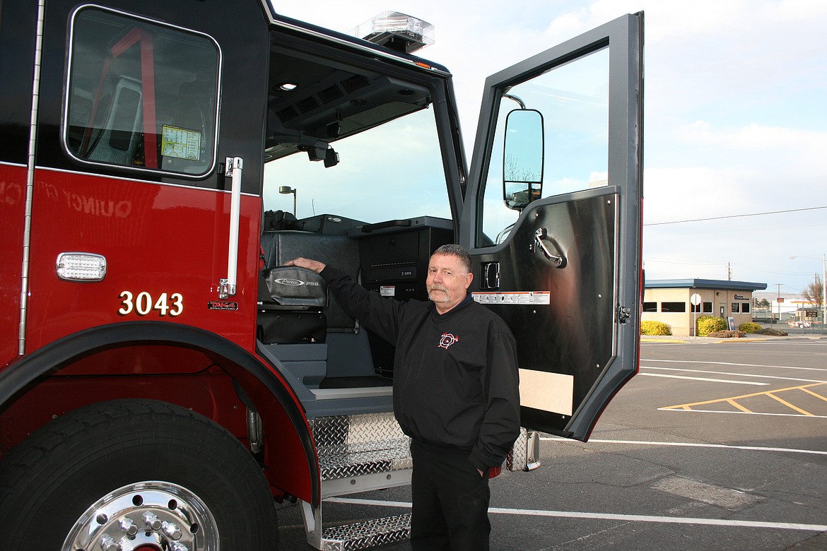 Jim Stucky, Grant County Fire District 3, shows off the new city of Quincy fire truck on its delivery day Tuesday.