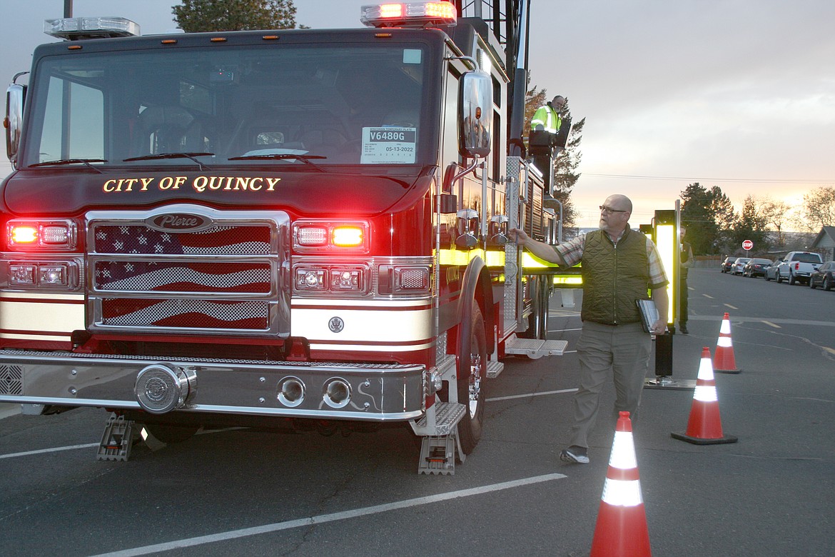 Carl Worley, Quincy Municipal Services director, looks over the city’s new fire truck after its arrival Tuesday.