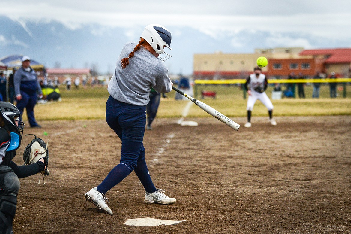 Glacier's Alli Kernan (11) connects on a three-run home run as part of the Wolfpack's nine run second inning against Flathead at Glacier High School on Thursday, April 21. (Casey Kreider/Daily Inter Lake)