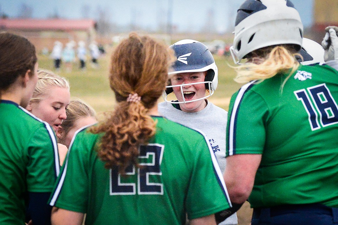 Glacier's Alli Kernan (11) celebrates with teammates as she crosses home plate after hitting a three-run home run as part of the Wolfpack's nine run second inning against Flathead at Glacier High School on Thursday, April 21. (Casey Kreider/Daily Inter Lake)