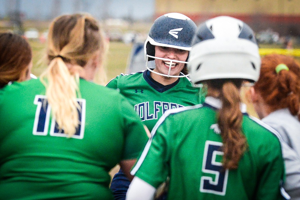 Glacier's Sammie Labrum (1) is congratulated by her teammates at home plate after her two-run home run in the second inning against Flathead at Glacier High School on Thursday, April 21. (Casey Kreider/Daily Inter Lake)