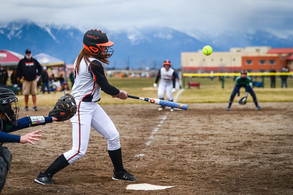 Flathead's Ava Bessen (6) drives in a run with an RBI single in the second inning against Glacier at Glacier High School on Thursday, April 21. (Casey Kreider/Daily Inter Lake)