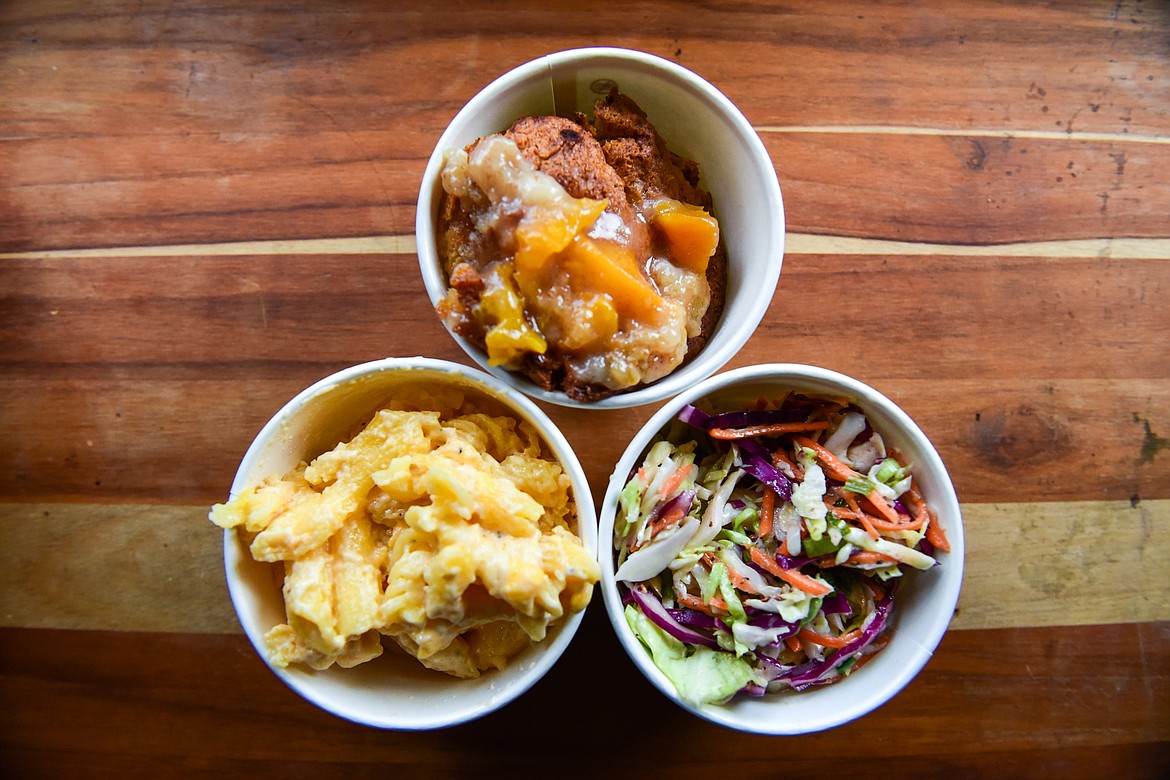 Macaroni and cheese, gluten-free peach cobbler and coleslaw from the Arn's BBQ food truck in Kalispell on Wednesday, April 20. (Casey Kreider/Daily Inter Lake)