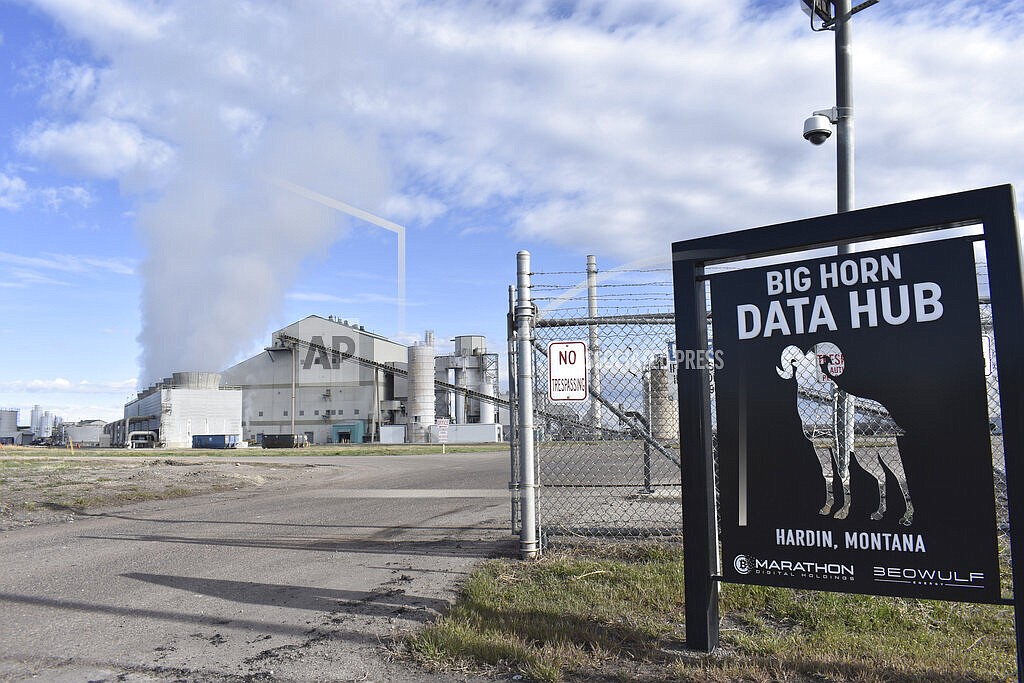 The Hardin Generating Station, a coal-fired power plant that is also home to the cryptocurrency "mining" operation Big Horn Data Hub, is seen on April 20, 2022, in Hardin, Mont. Energy from burning coal is used to power thousands of computers that are kept on site to produce the digital currency known as bitcoins. (AP Photo/Matthew Brown)