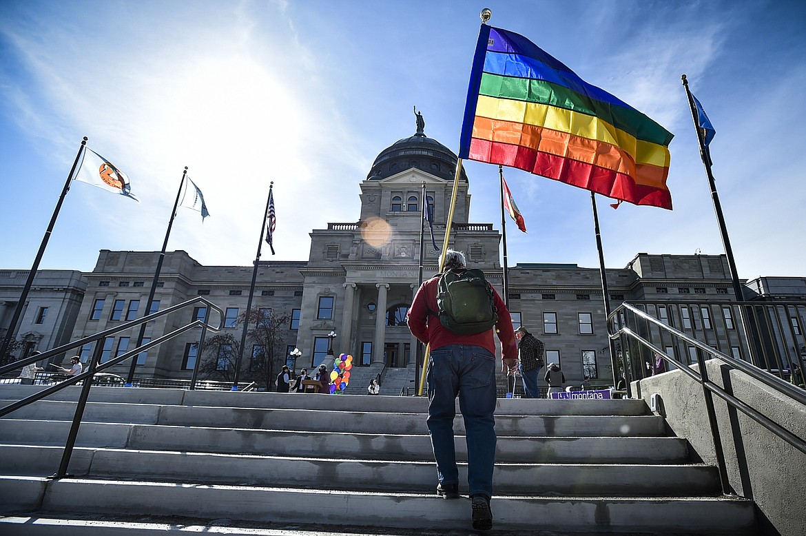 FILE - In this March 15, 2021, file photo, demonstrators gather on the steps of the Montana State Capitol protesting anti-LGBTQ+ legislation in Helena, Mont. A Montana judge on Thursday, April 21, 2022 has granted a temporary restraining order against a law that makes it difficult for transgender people to change the sex on their birth certificates. (Thom Bridg/Independent Record via AP, File)