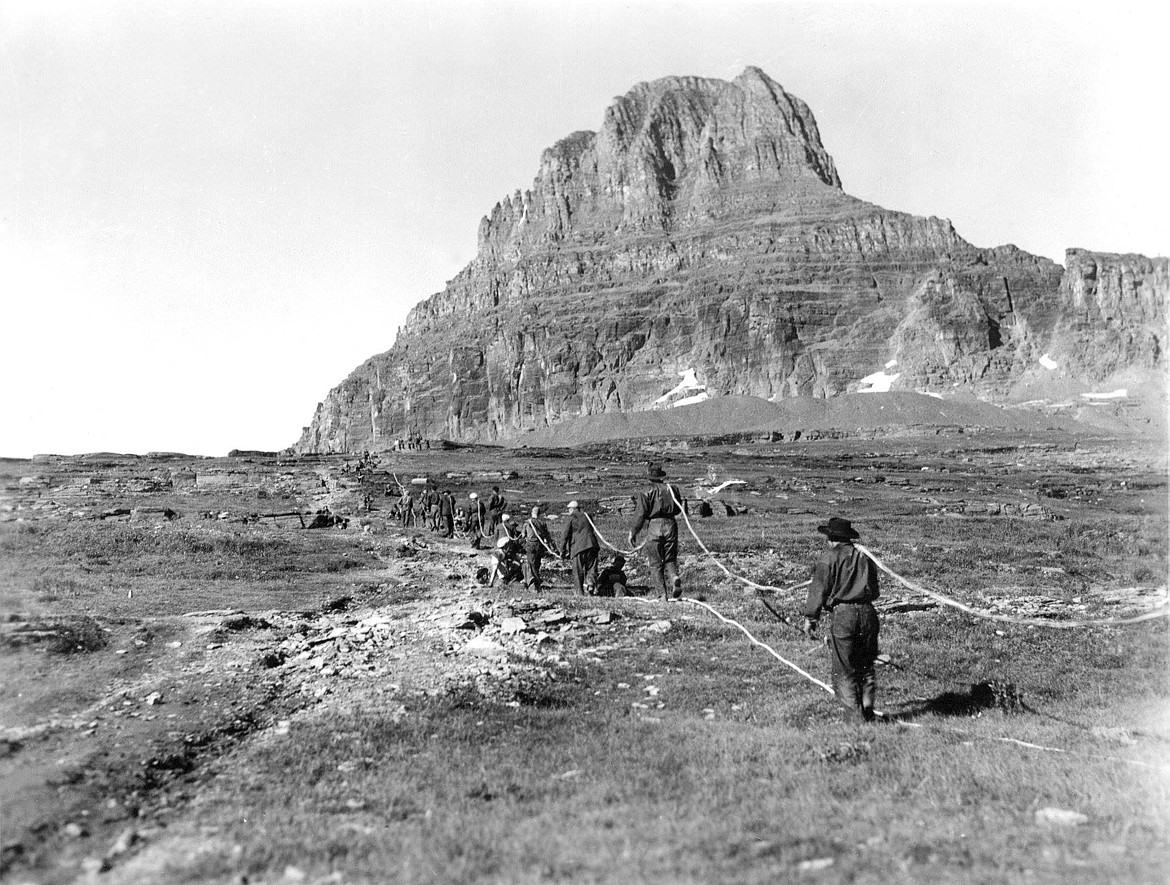 Crews carry a trans-park phone line up and over Hidden Pass. (Photo provided)