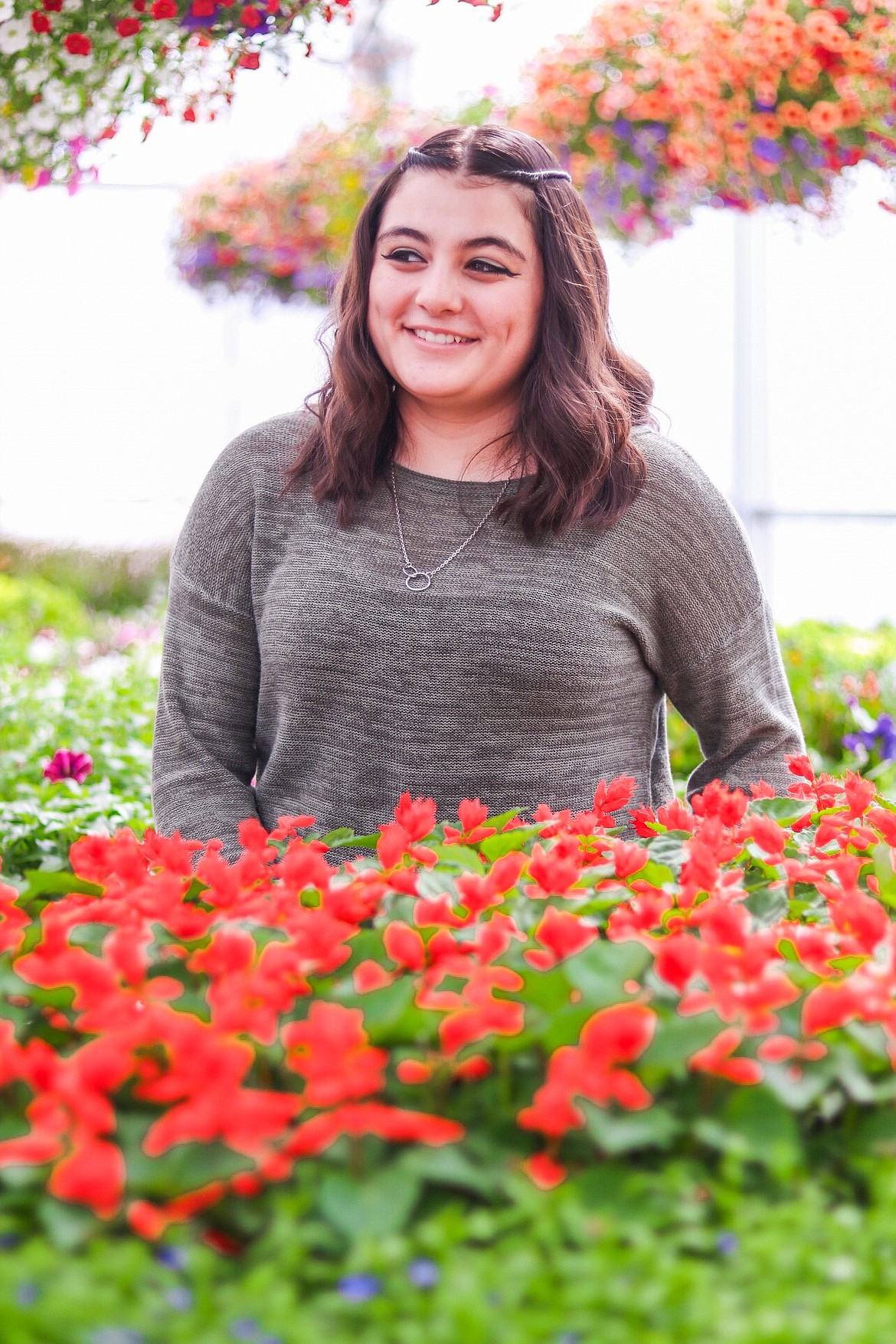 Quincy High School student Iris Ramirez in the QHS greenhouse. The annual QHS FFA plant sale starts tomorrow