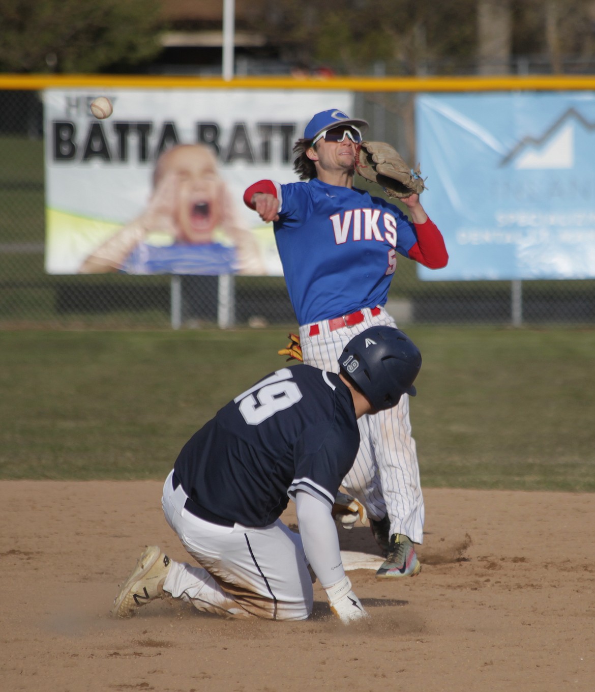 MARK NELKE/Press
Coeur d'Alene second baseman Evan Mallory (5) tries to turn two as Parker Rimpau of Lake City slides into second base on Friday at Coeur d'Alene High.