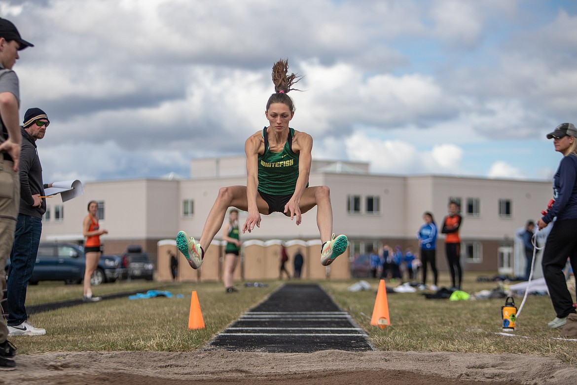 Whitefish’s Erin Wilde competes in the long jump at the Iceberg Invitational on Saturday, April 23, in Columbia Falls. Wilde’s 16-foot-9 jump was her best of the season. She also won the high jump. (JP Edge/Hungry Horse News)