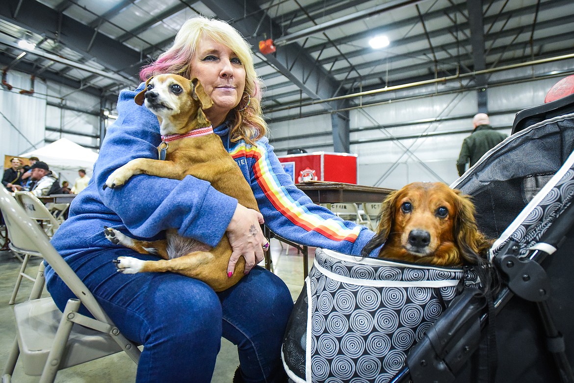 Dawn Robinson takes a break with her dogs Snicker, left, a rescue Chiweenie, and Harley, a long-haired mini Dachshund, at the Flathead Kennel Club Canine Expo at the Flathead County Fairgrounds Trade Center on Saturday, April 23. A Chiweenie is a Chihuahua/Dachshund mix. (Casey Kreider/Daily Inter Lake)