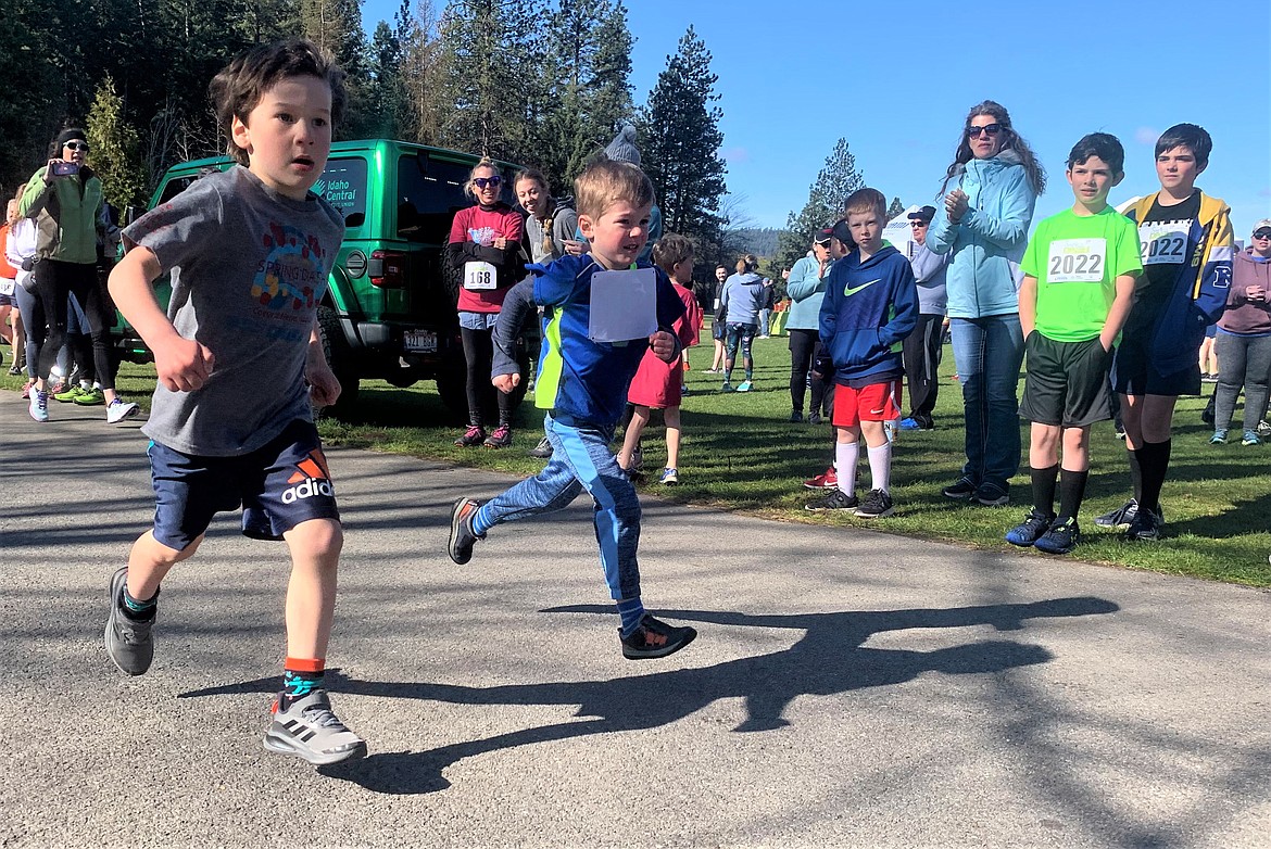 Jackson Martin, left, and Peter Amador battle it out as they sprint to the finish of the Tot Trot on Saturday at McEuen Park.