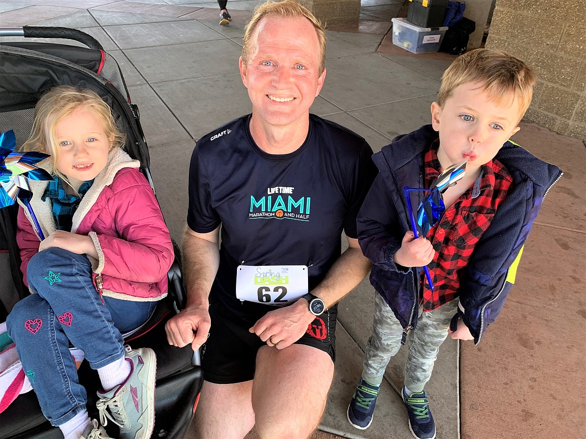 Nik Cannell sits with kids Dean and Marjorie after the Spring Dash. He pushed them in a stroller through the five-mile race on Saturday that finished at McEuen Park.