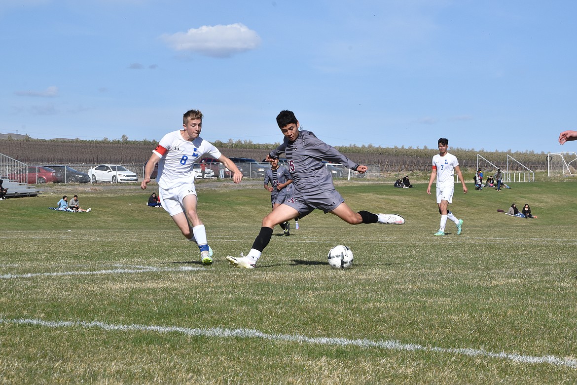 Wahluke High School sophomore Diego Perez (15) goes in for a goal as a La Salle player comes in to block the shot on April 21.