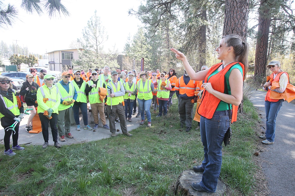 Hosanna Schumacher organizes volunteers for deployment to different areas along I-90 and nearby parks for the Trash Tag Challenge cleanup event Sunday.