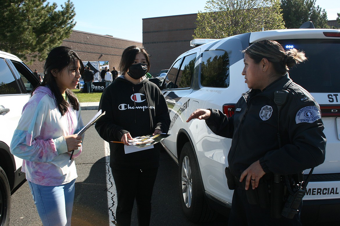 Mireya Antunez (right)  talks with Wahluke High School students during the Outdoor Career Fair Friday at WHS. Antunez discussed opportunities offered by the Washington State Patrol with attendees at the event, many of whom hadn’t considered law enforcement as an option before.